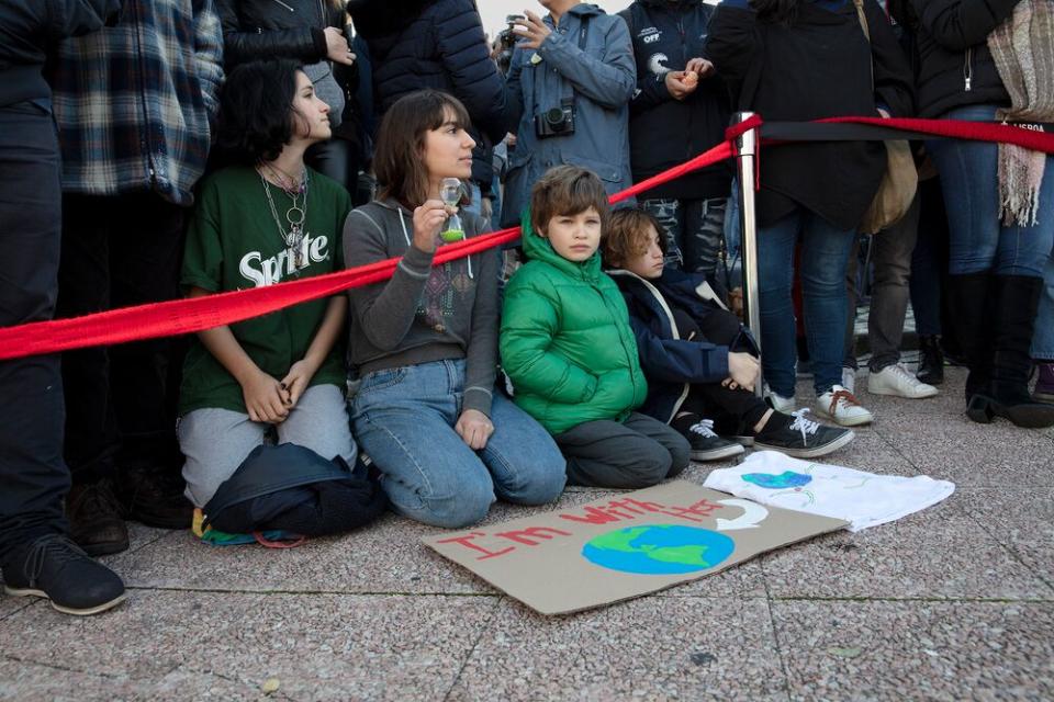 Young supporters of Greta Thunberg await her arrival in Santo Amaro Recreation dock on December 03, 2019 in Lisbon, Portugal. | Evgenia Arbugaeva for TIME