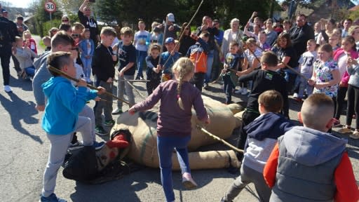 Children beat an effigy of Judas on Good Friday in the town of Pruchnik, Poland