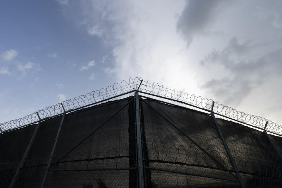 In this photo reviewed by U.S. military officials, a fence is seen at Camp Justice, Sunday, Aug. 29, 2021, in Guantanamo Bay Naval Base, Cuba. Camp Justice is where the military commission proceedings are held for detainees charged with war crimes. (AP Photo/Alex Brandon)