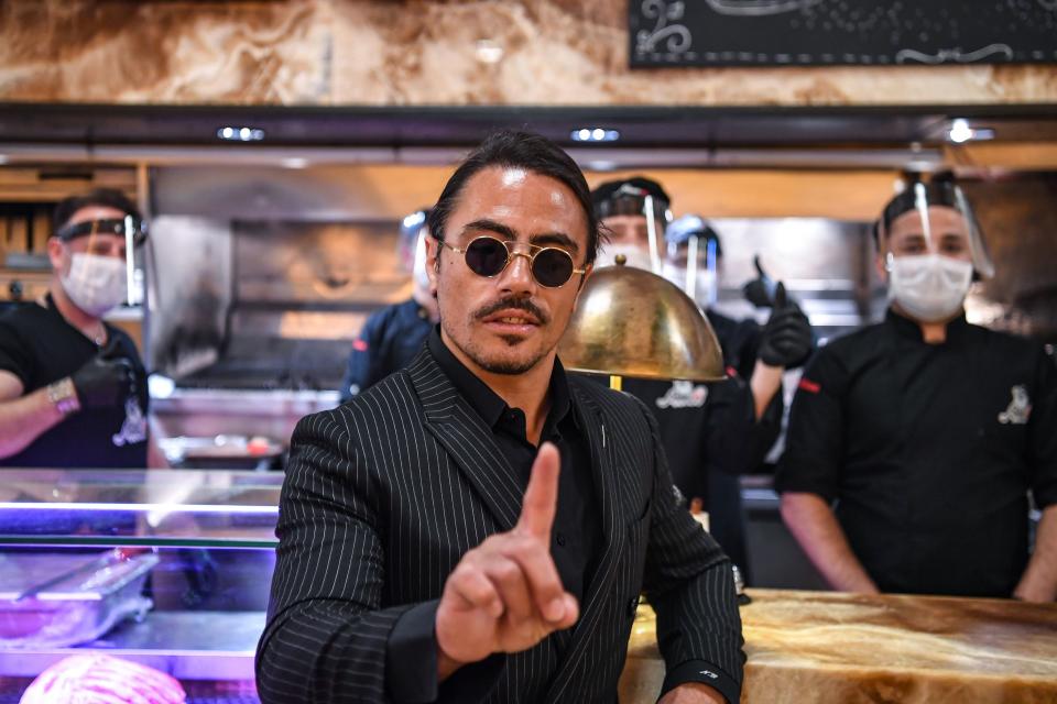 Turkish restaurateur Nusret Gokce, also known as 'Salt Bae', poses for photos at his restaurant 'Nusr-Et' at the Grand Bazaar after its reopening on June 1, 2020 in Istanbul. - Turkey reopened restaurants, cafes and Istanbul's iconic 15th century Grand Bazaar market on June 1 as the government further eased coronavirus restrictions. Many other facilities including parks, beaches, libraries and museums also reopened across the country, while millions of public sector employees returned to work. (Photo by Ozan KOSE / AFP) (Photo by OZAN KOSE/AFP via Getty Images)