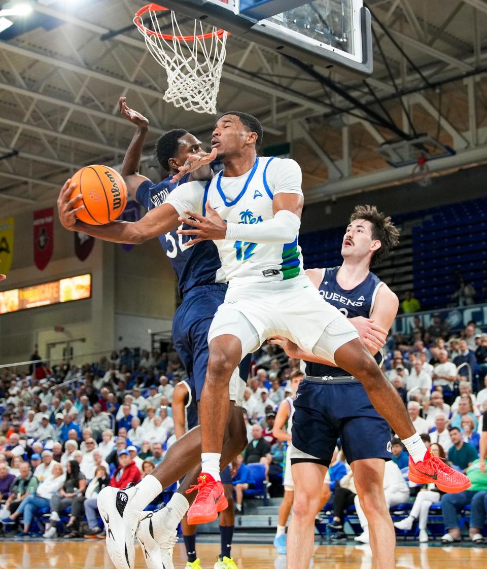 Florida Gulf Coast Eagles guard Franco Miller Jr. (12) is fouled while making a lay up during the first half of an ASUN conference game against the Queens Royals at Alico Arena in Fort Myers on Saturday, Feb. 24, 2024.