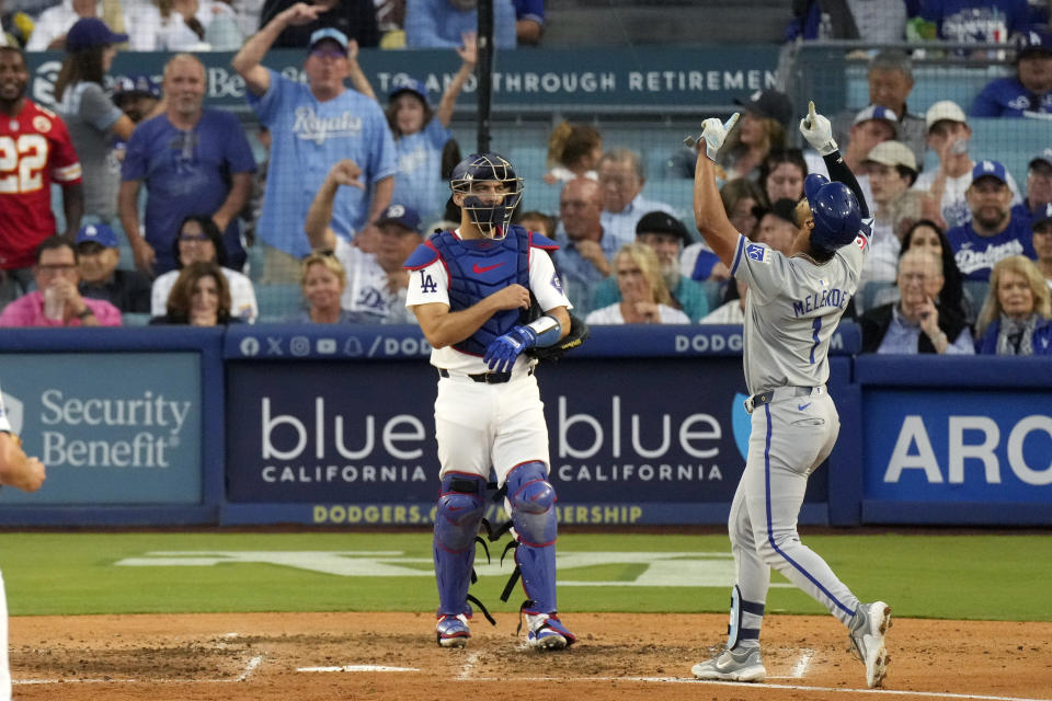 Kansas City Royals' MJ Melendez, right, gestures as he scores after hitting a grand slam as Los Angeles Dodgers catcher Austin Barnes stands by during the sixth inning of a baseball game Saturday, June 15, 2024, in Los Angeles. (AP Photo/Mark J. Terrill)