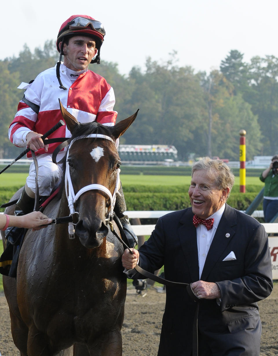 FILE - In this Sept. 3, 2011, file photo, Havre de Grace, left, with Ramon Dominguez aboard, is escorted to the Winner's Circle by owner Rick Porter, right, after winning the 58th Running of the Woodward Stakes Horse Race at Saratoga Race Course in Saratoga Springs, N.Y. Porter, a successful owner who campaigned such top thoroughbreds as 2011 Horse of the Year Havre de Grace and ill-fated Kentucky Derby runner-up Eight Belles, has died. He was 80. (AP Photo/Hans Pennink, File)