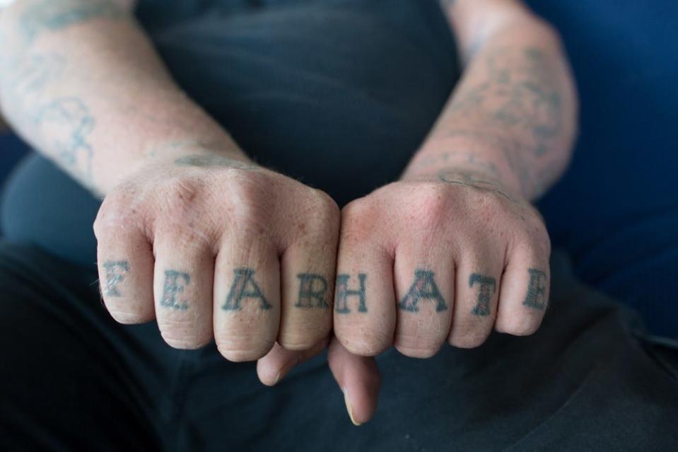 <div class="inline-image__caption"><p>"Ronald “Dozer” Pulcher II, a leader of Aryan Strike Force displays his FEAR/HATE tattoos at his home."</p></div> <div class="inline-image__credit">Courtesy Anthony Karen</div>