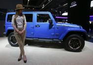 A model poses next to a Jeep Wrangler Unlimited during a media preview day at the Frankfurt Motor Show (IAA) September 10, 2013. The world's biggest auto show is open to the public September 14 -22. REUTERS/Wolfgang Rattay (GERMANY - Tags: BUSINESS TRANSPORT)