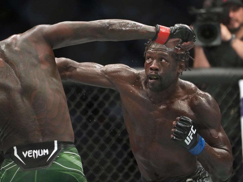 Jul 2, 2022; Las Vegas, Nevada, USA; Israel Adesanya (red gloves) and Jared Cannonier (blue gloves) fight in a bout during UFC 276 at T-Mobile Arena. Mandatory Credit: Stephen R. Sylvanie-USA TODAY Sports