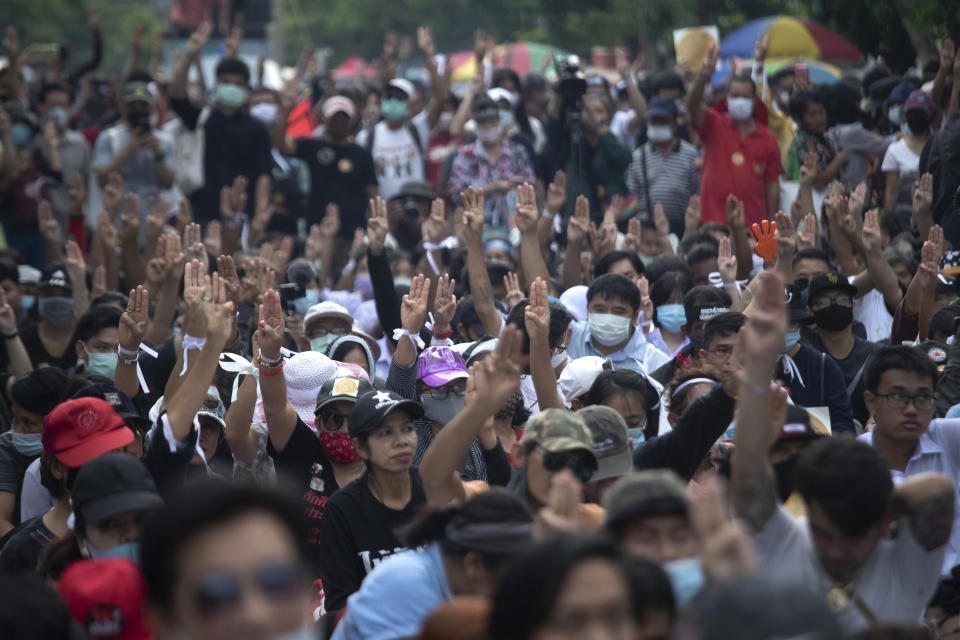 Pro-democracy demonstrators raise a three-finger salute, a symbol of resistance, during a protest outside the Parliament in Bangkok, Thailand, Thursday, Sept. 24, 2020. Lawmakers in Thailand are expected to vote Thursday on six proposed amendments to the constitution, as protesters supporting pro-democratic charter reforms gathered outside the parliament building. (AP Photo/Sakchai Lalit)