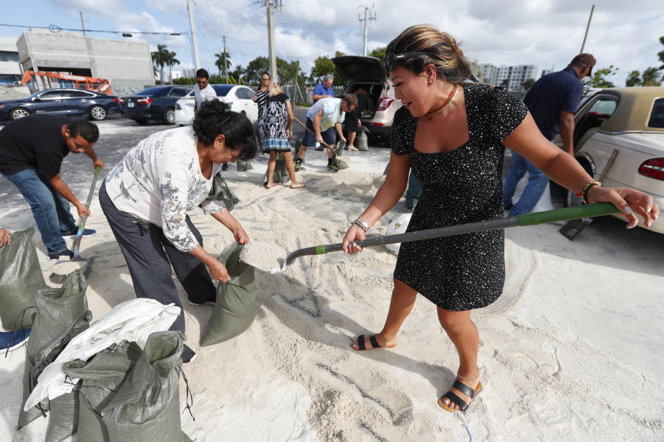 Georgia Bernard, right, and Ana Perez are among residents filling sandbags to take home in preparation for Hurricane Dorian, Friday, Aug. 30, 2019, in Hallandale Beach, Fla., as the town allowed residents to fill up sandbags until they ran out. All of Florida is under a state of emergency and authorities are urging residents to stockpile a week&#39;s worth of food and supplies as Hurricane Dorian gathers strength and aims to slam the state as soon as Monday as a Category 4 storm. (AP Photo/Wilfredo Lee)