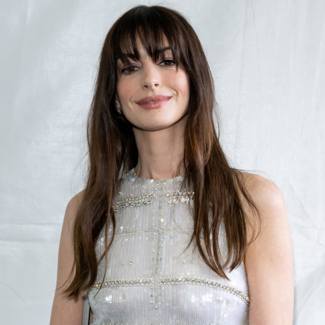  Anne Hathaway with bangs and closed-mouth smile. 