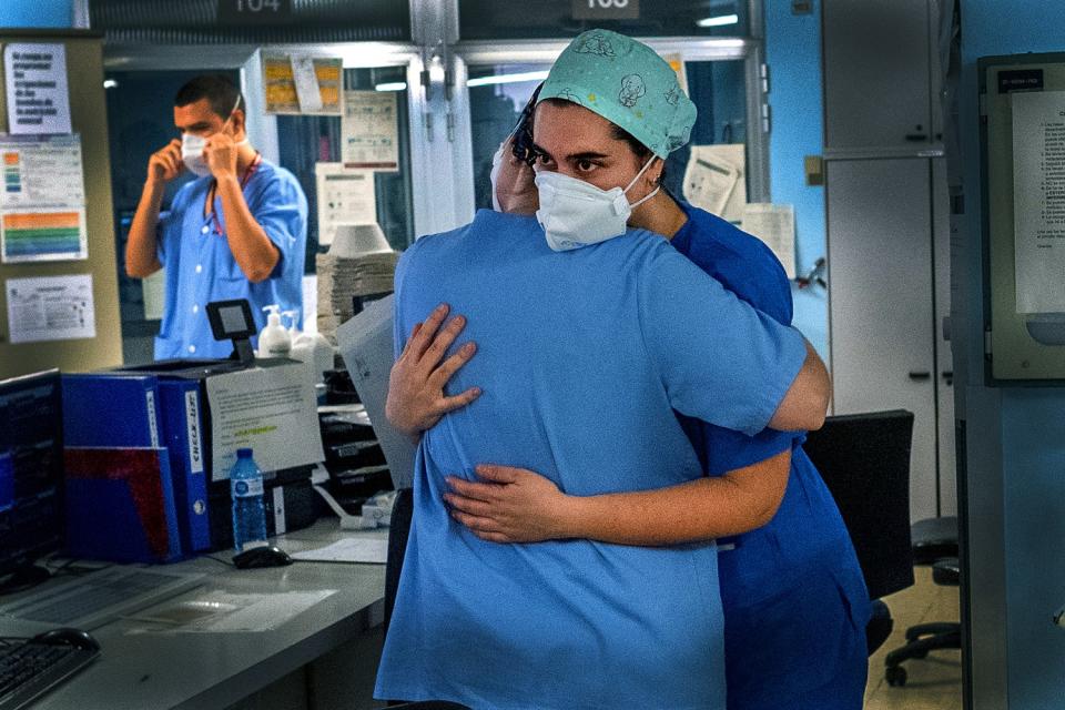 SPAIN: Staffers embrace in the intensive care unit at Bellvitge University Hospital in Llobregat near Barcelona on April 9.