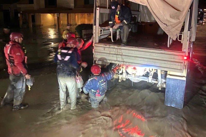 California National Guard members wade through floodwaters in Palm Springs, Calif., late Sunday while assisting local first responders in rescue operations in the wake of Post-Tropical Cyclone Hilary. Photo Courtesy California National Guard/X