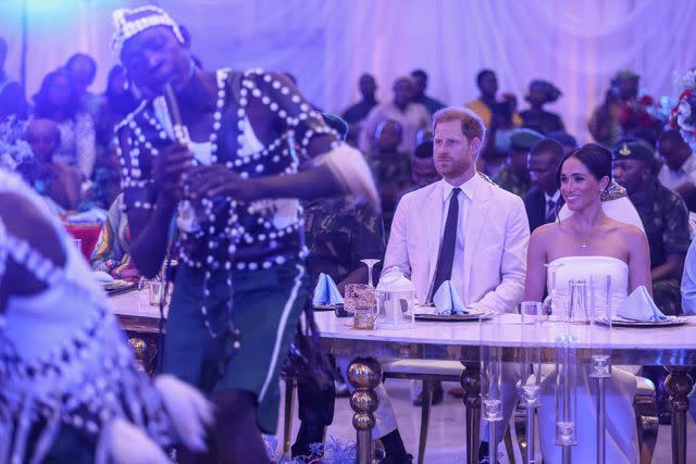 <p>KOLA SULAIMON/AFP via Getty </p> Prince Harry and Meghan Markle on May 11 at a reception in Abuja, Nigeria