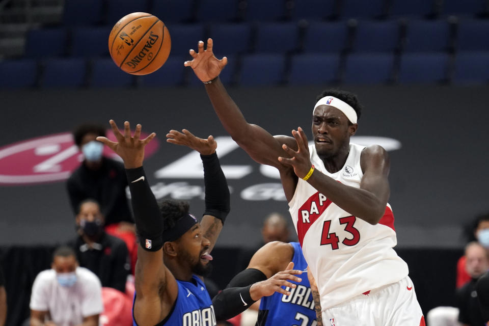 Toronto Raptors forward Pascal Siakam (43) passes the ball over Orlando Magic guard Terrence Ross (31) during the second half of an NBA basketball game Sunday, Jan. 31, 2021, in Tampa, Fla. (AP Photo/Chris O'Meara)