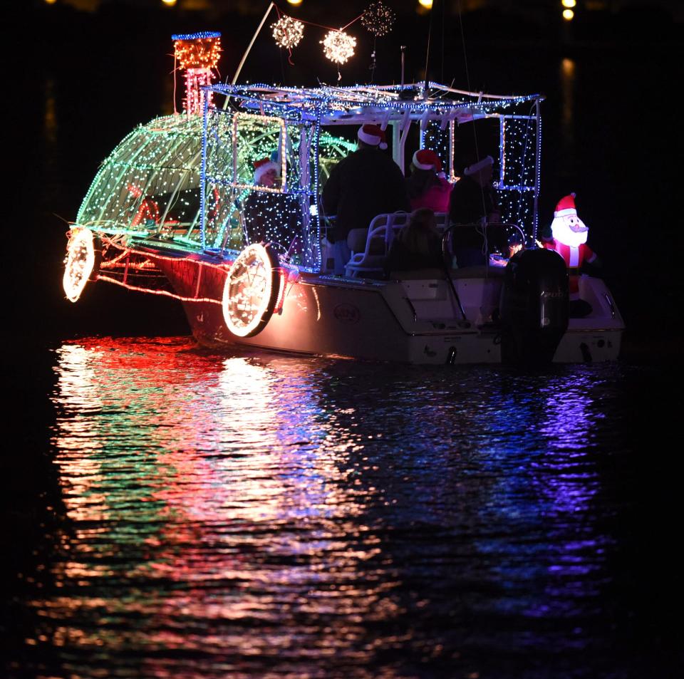 Boats gather in Snow's Cut at the start of the Island of Lights Christmas Flotilla in Carolina Beach, N.C. Saturday, December 3, 2016.