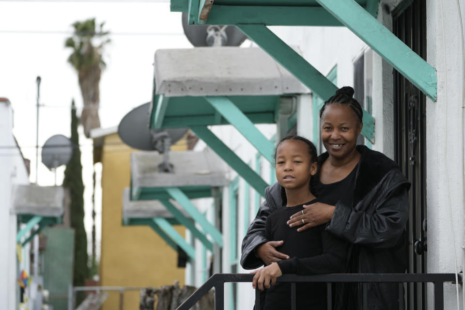 Miesha Clarke and her 10-year-old son, Ezekiel West, stand for a portrait outside their home in Los Angeles on Sunday, Jan. 15, 2023. During online learning, his mother couldn’t get home internet and struggled with the WiFi hotspots provided by the school. She worked as a home health aide and couldn’t monitor Ezekiel online. (AP Photo/Damian Dovarganes)