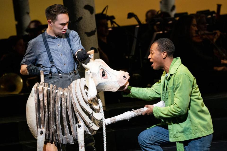 Pupeteer Kennedy Kanagawa with the cow Milky White, who belongs to Cole Thompson’s Jack in “Into the Woods.” The poor cow plays a pivotal part in the show.