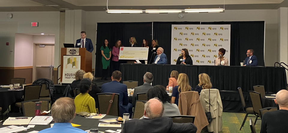 Micah Kiel, vice president of community relations and philanthropy at Wells Fargo, announces a company commitment of $650,000 to Iowa Legal Aid's eviction prevention project.