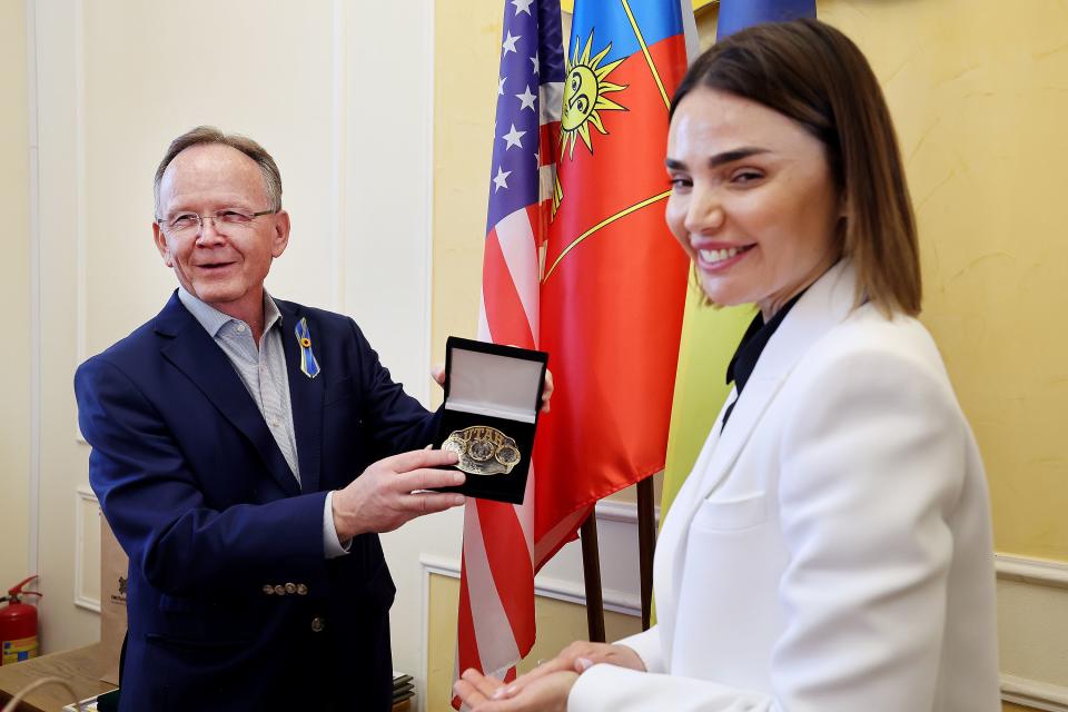 Utah Senate President Stuart Adams presents a belt buckle to Violetta Labazuik, head of the Khmelnytskyi Regional Council, after after a meeting on Monday, May 1, 2023, in Ukraine. | Scott G Winterton, Deseret News