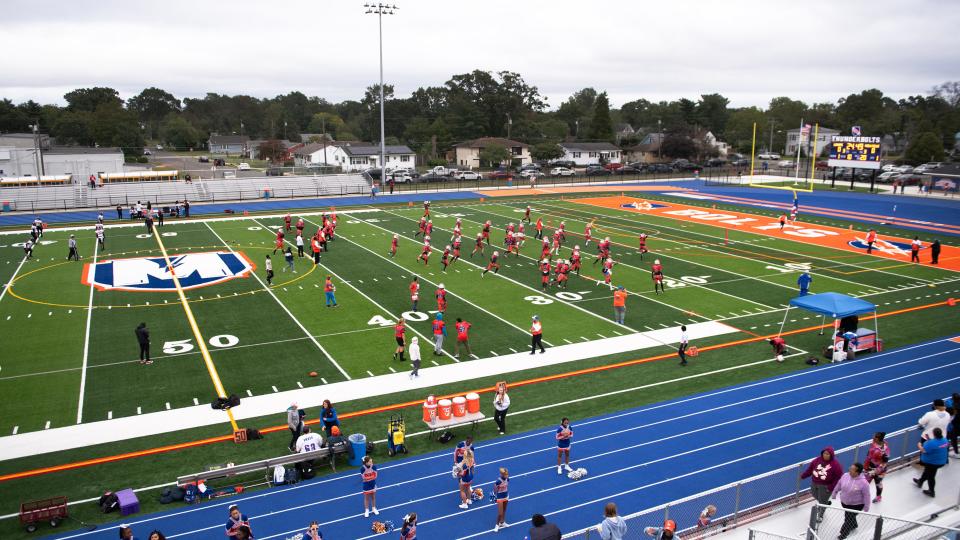 Members of the Millville High School football team take to the new turf field at the newly refurbished John Barbose Stadium at Wheaton Field in Millville prior to the football game between Millville and Lenape on Friday, September 29, 2023.  Millville defeated Lenape, 26-3.