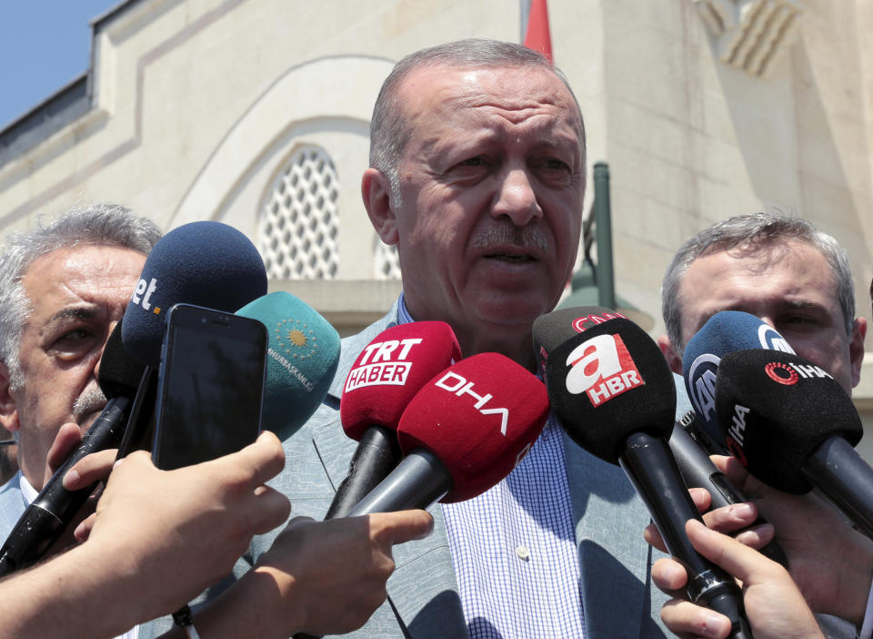 Turkish President Recep Tayyip Erdogan speaks to the media after Friday prayers, in Istanbul, Friday, June 7, 2019. Erdogan says his country is determined to protect Turkish Cypriots' rights to gas deposits in the eastern Mediterranean.(Presidential Press Service via AP, Pool)