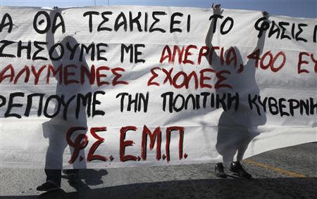 Protesters take part in an anti-government rally organised by public sector workers in central Athens September 24, 2013. REUTERS/John Kolesidis