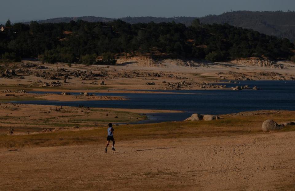 A park visitor runs on the dry Folsom Lake bottom in Granite Bay.