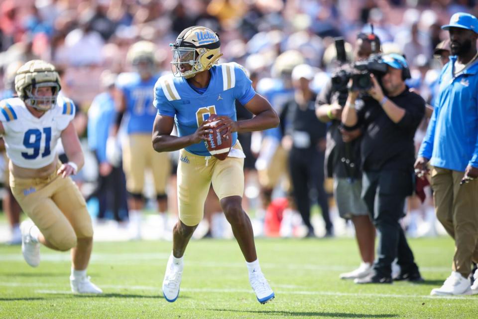 UCLA quarterback Justyn Martin runs a play during the UCLA football spring showcase at the Rose Bowl on Saturday.