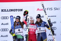 Switzerland's Lara Gut-Behrami, first place, center, and Italy's Marta Bassino, second place, left, and Sweden's Sara Hector, third place, acknowledge applause on the podium following a World Cup giant slalom skiing race Saturday, Nov. 26, 2022, in Killington, Vt. (AP Photo/Robert F. Bukaty)