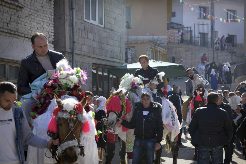 Bulgarian muslims take part in a procession during mass circumcision ceremony in the village of Ribnovo, Bulgaria, Sunday, April 11, 2021. Despite the dangers associated with COVID-19 and government calls to avoid large gatherings, Hundreds of people flocked to the tiny village of Ribnovo in southwestern Bulgaria for a four-day festival of feasting, music and the ritual of circumcision which is considered by Muslims a religious duty and essential part of a man's identity. (AP Photo/Jordan Simeonov)