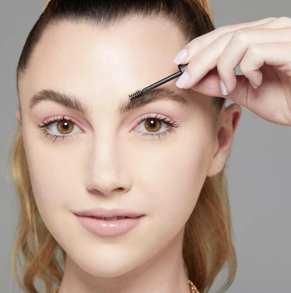 a model applying the brow glue