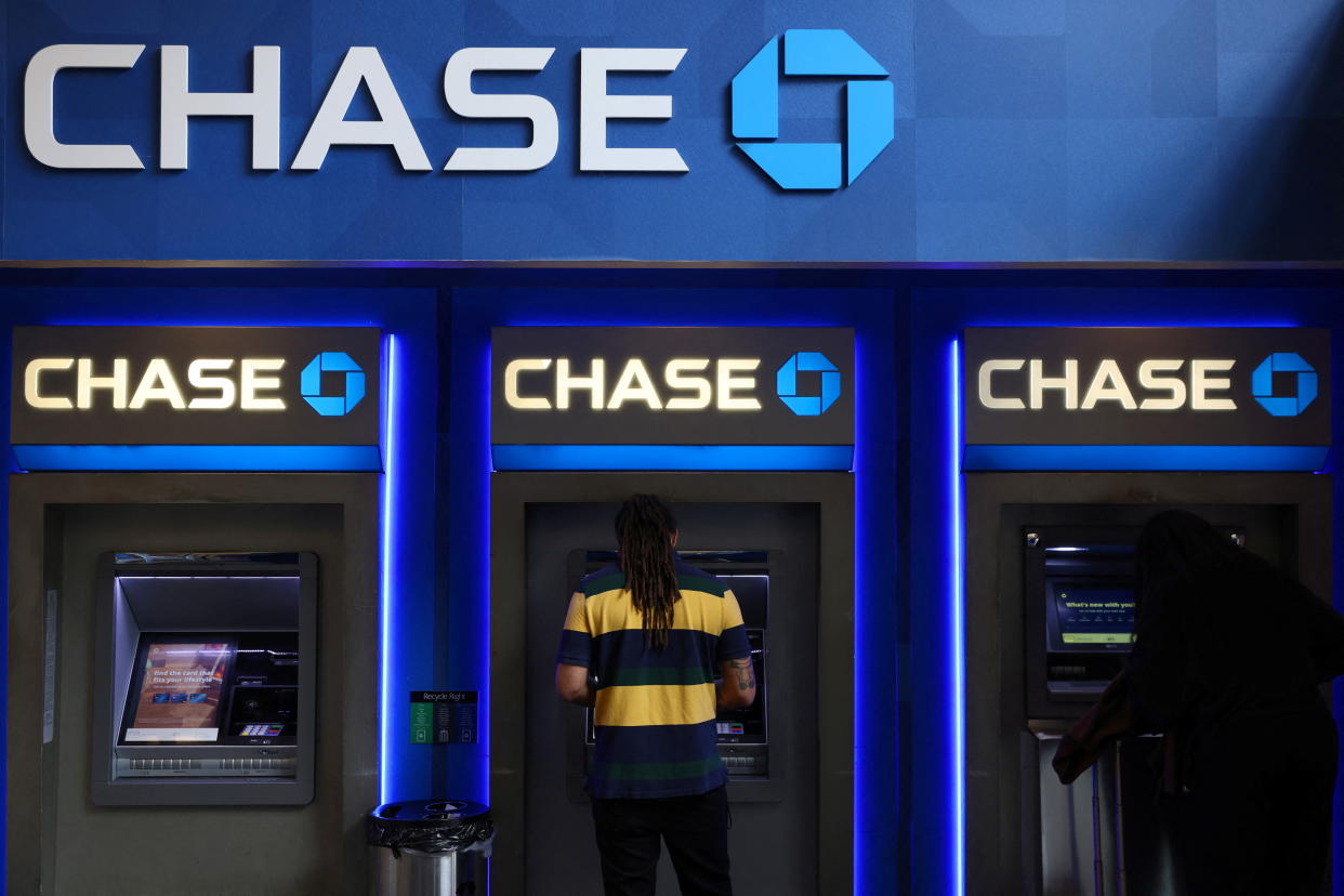 People use ATMs at a Chase Bank branch in Manhattan, New York City, U.S., May 20, 2022. REUTERS/Andrew Kelly