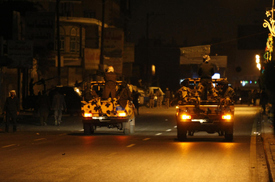 Yemeni soldiers in vehicles patrol a street leading to the central prison after an explosions that took place nearby in Sanaa, Yemen, Thursday, Feb. 13, 2014. Witnesses said explosions have rocked the Yemeni capital near the central prison followed by heavy gunfire and smoke billowing into the sky. (AP Photo/Hani Mohammed)