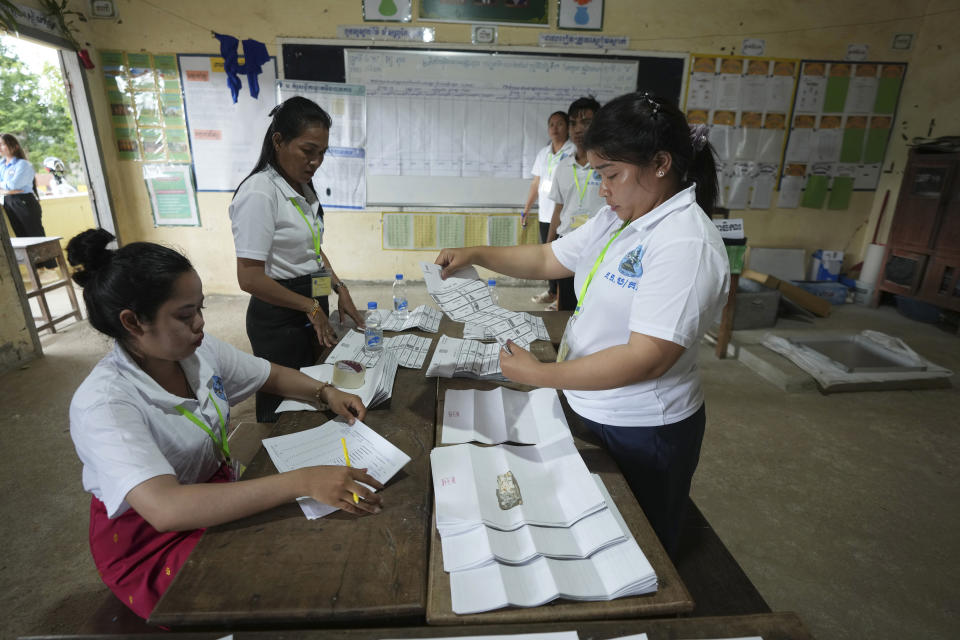 Polling station members count ballots at Toul Snoa primary school outside Phnom Penh, Cambodia, Sunday, July 23, 2023. (AP Photo/Heng Sinith)