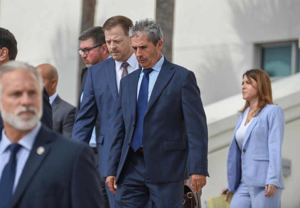 Carlos De Oliveira (center) and his Washington D.C. attorney John Irving leave the Federal Courthouse in Fort Pierce on Thursday, Aug 10, 2023, after appearing before U.S. Magistrate Shaniek Mills Maynard to face new charges added July 27 to an indictment in the classified documents case. De Oliveira did not enter a plea but rescheduled the arraignment for Tuesday, Aug. 15. Waltine "Walt" Nauta's attorney Sasha Dadan (right), of Fort Pierce, follows behind.