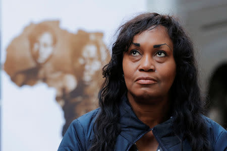 Tamara Lanier listens as her lawyer speaks to the media about a lawsuit accusing Harvard University of the monetization of photographic images of her great-great-great grandfather, an enslaved African man named Renty, and his daughter Delia, outside of the Harvard Club in New York, U.S., March 20, 2019. REUTERS/Lucas Jackson