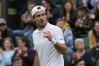 Argentina's Guido Pella celebrates winning a point against Italy's Matteo Berrettini during the men's singles first round match on day three of the Wimbledon Tennis Championships in London, Wednesday June 30, 2021. (AP Photo/Kirsty Wigglesworth)