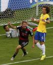 Germany's Thomas Mueller (C) celebrates past Brazil's David Luiz and goalkeeper Julio Cesar after scoring a goal during their 2014 World Cup semi-finals at the Mineirao stadium in Belo Horizonte July 8, 2014. REUTERS/David Gray