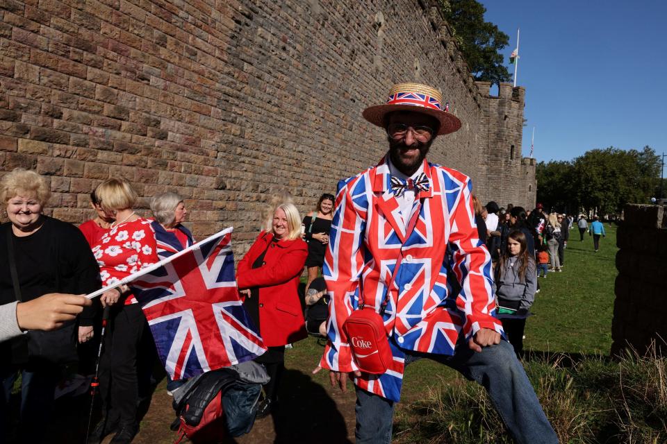 A member of the public wearing a Union flag-themed blazer poses for a photograph outside St Llandaff Cathedral in Cardiff (AFP via Getty Images)