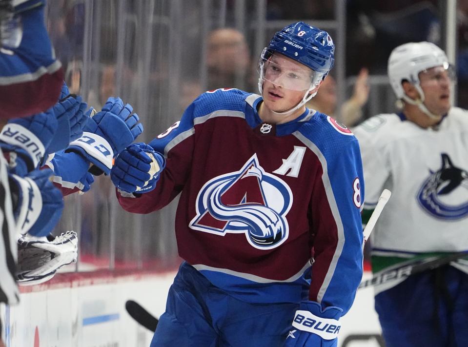 Colorado Avalanche defenseman Cale Makar (8) celebrates a goal against the Vancouver Canucks during the second period of an NHL hockey game Wednesday, Nov. 23, 2022, in Denver. (AP Photo/Jack Dempsey)