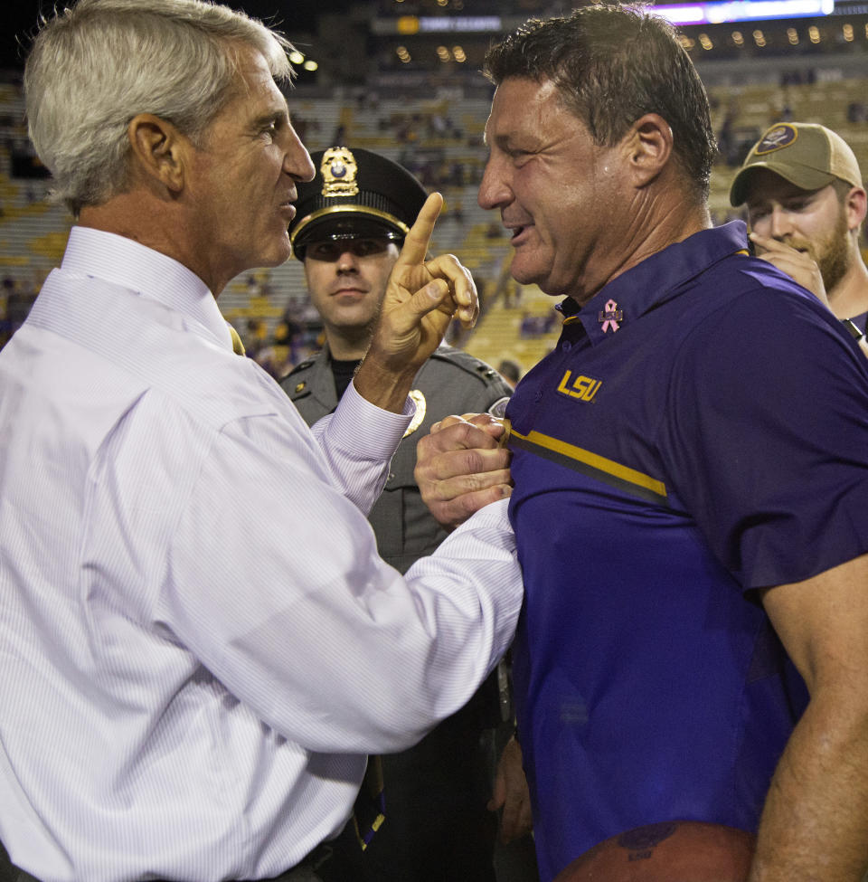 LSU athletic director Joe Alleva, left, is on the hook for his hire of Ed Orgeron. (AP)