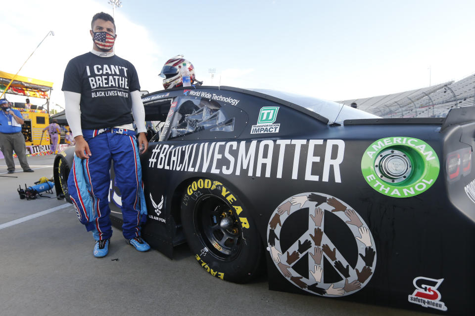 FILE - In this June 10, 2020, file photo, driver Bubba Wallace waits for the start of a NASCAR Cup Series auto race in Martinsville, Va. Bubba Wallace now counts Spike Lee and Demi Lovato – his admitted celebrity crush – as those loudly in his corner since he’s become the leader of NASCAR’s push for change. (AP Photo/Steve Helber, File)