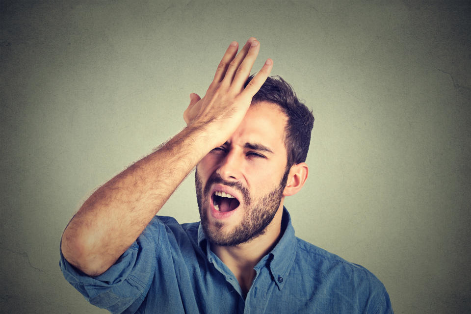 A man hits his forehead with his hand