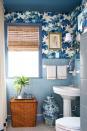 <p>Don't let tiny rooms deter you from going big. Interior designer <a href="http://shaunsmithhome.com/" rel="nofollow noopener" target="_blank" data-ylk="slk:Shaun Smith's;elm:context_link;itc:0;sec:content-canvas" class="link ">Shaun Smith's</a> New Orleans home is a treasure trove of beautiful and clever design solutions. If your bathroom is too small for shelves with a lot of depth, add extra storage by placing a tray over the hamper. Keep your hand towels and florals there to brighten up the room. And most importantly, have fun with color.</p>