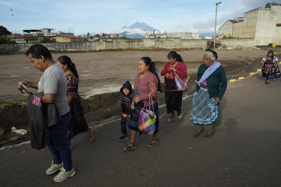 Voters arrive to a poling station during general elections in Sumpango, Guatemala, Sunday, March 25, 2023. (AP Photo/Moises Castillo)
