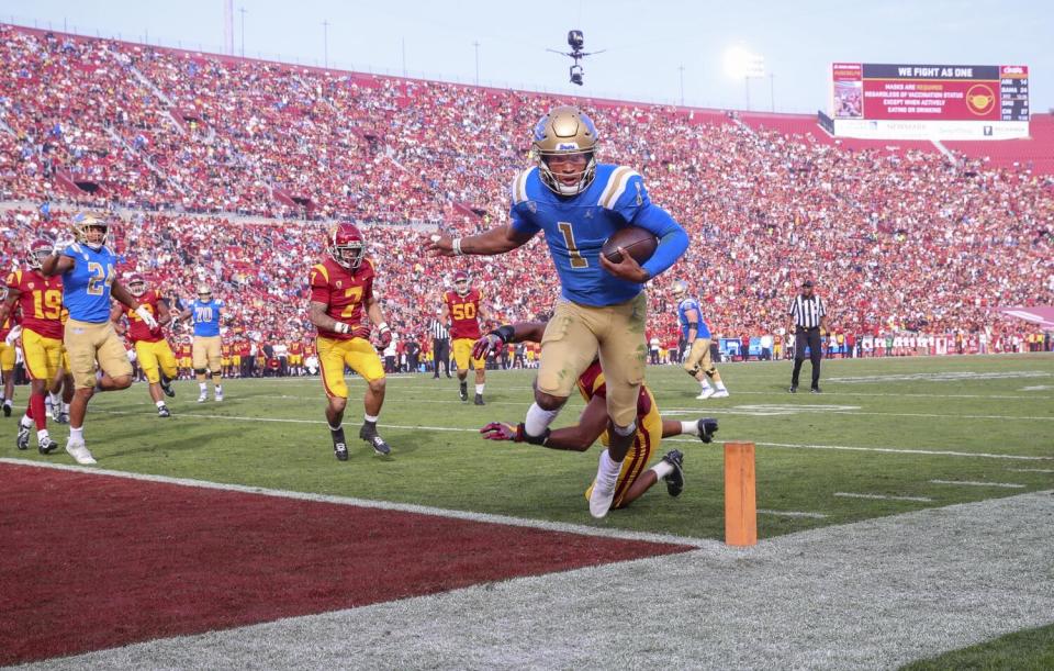 UCLA quarterback Dorian Thompson-Robinson scores past USC linebacker Ralen Goforth