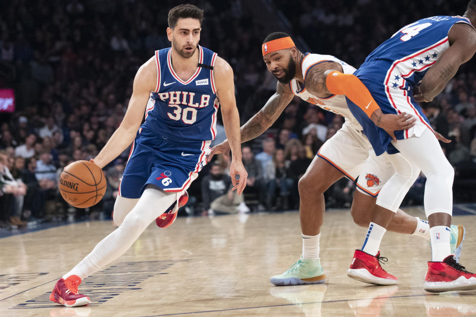 Philadelphia 76ers guard Furkan Korkmaz (30) drives against New York Knicks forward Marcus Morris Sr. (13) in the first half of an NBA basketball game, Saturday, Jan. 18, 2020, at Madison Square Garden in New York. (AP Photo/Mary Altaffer)