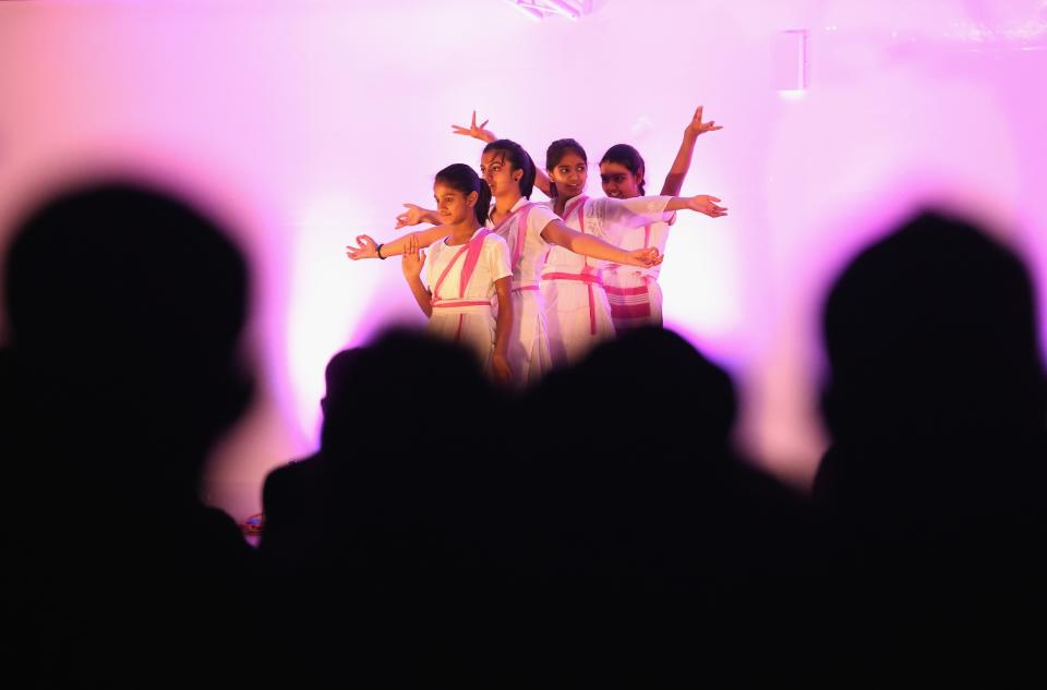 LEICESTER, UNITED KINGDOM - NOVEMBER 13: Young dancers entertain the crowds during the Hindu festival of Diwali on November 13, 2012 in Leicester, United Kingdom. Up to 35,000 people attended the Diwali festival of light in Leicester's Golden Mile in the heart of the city's asian community. The festival is an opportunity for Hindus to honour Lakshmi, the goddess of wealth and other gods. Leicester's celebrations are one of the biggest in the world outside India. Sikhs and Jains also celebrate Diwali. (Photo by Christopher Furlong/Getty Images)