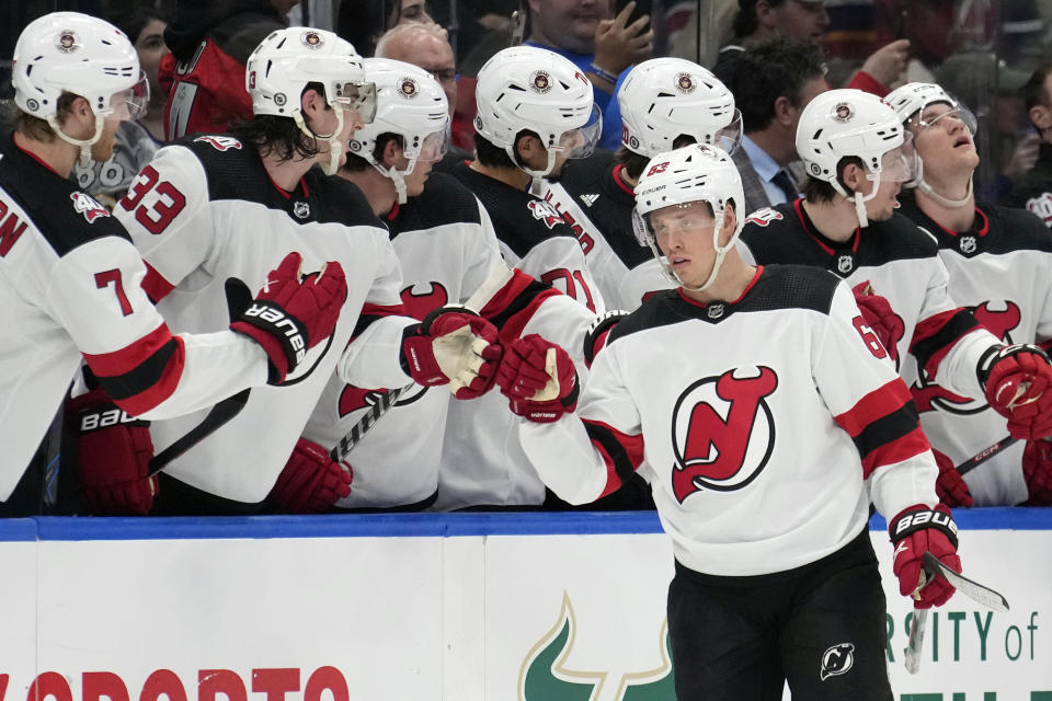 New Jersey Devils left wing Jesper Bratt (63) celebrates with the bench after his goal against the Tampa Bay Lightning during the.second period of an NHL hockey game Sunday, March 19, 2023, in Tampa, Fla. (AP Photo/Chris O'Meara)