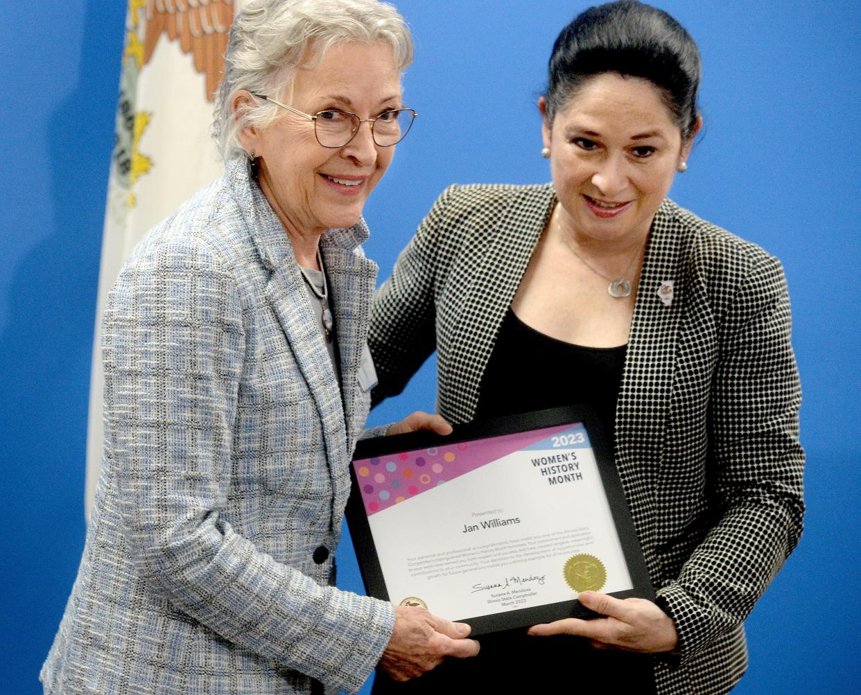 Springfield resident and founder of the James Project Jan Williams, left, receives an award from Illinois State Comptroller Susana Mendoza at the Let's Celebrate Woman's History Month ceremony Wednesday, March 15, 2023.