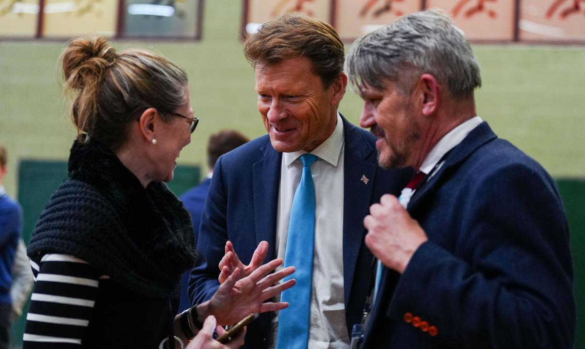 Richard Tice (centre) leader of the Reform UK party waits ahead of the declaration during the count for the Blackpool South by-election at Blackpool Sports Centre, Blackpool. The by-election was triggered after the resignation of Scott Benton. Picture date: Friday May 3, 2024.